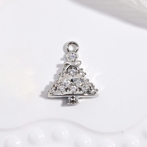 Macro detail of silver Christmas tree pendant with sparkling rhinestones and bow accent