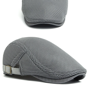 Close-up of grey breathable mesh fabric and adjustable metal buckle on a flat ivy cap