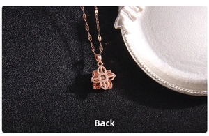 Detailed back view of rotating four-leaf clover pendant in polished rose gold finish