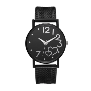 Detail of black mesh strap and round dial with heart motifs on women's quartz watch
