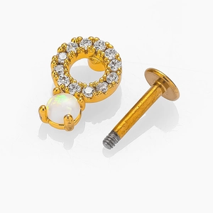 Bijou de piercing doré avec zircon et opale présenté en vue démontée