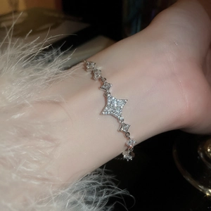Detailed view of silver star bracelet with sparkling zircons on a soft sleeve