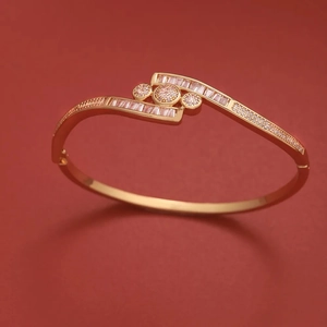 Macro shot of rose gold plated cuff bracelet with round and baguette zircon accents