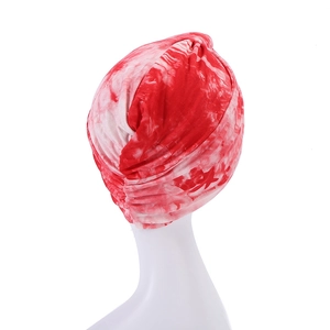 Detail of red and white tie-dye headscarf with ruched back design on a mannequin
