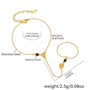 Gold stainless steel finger chain bracelet featuring black natural stones and heart detail