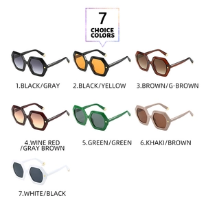 Flat lay of hexagonal fashion sunglasses in seven assorted colors on white backdrop