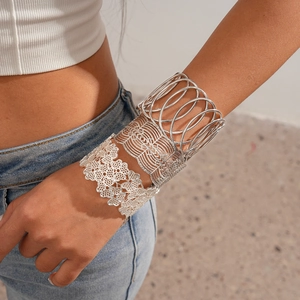 Silver open cuff bracelet set with geometric hollow patterns and floral cut-outs