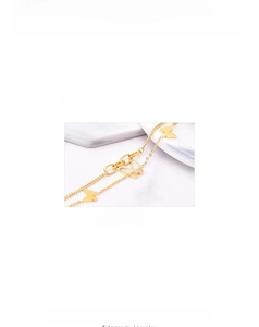 Macro detail of a 18k gold titanium double-layered bracelet with white shell butterfly charm