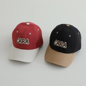 Detailed view of color-block kids baseball caps with high-quality CARA letter embroidery