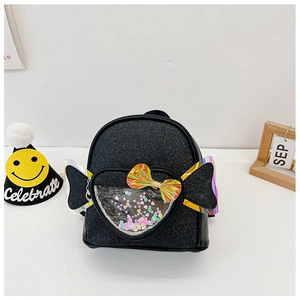 Detail of black sequin backpack with heart-shaped window and laser glitter wings