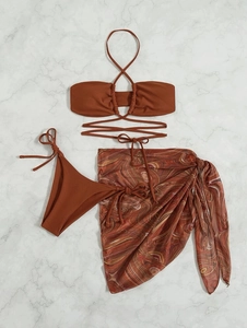 Detailed flat lay of a terracotta three-piece bikini set with a marble print mesh sarong
