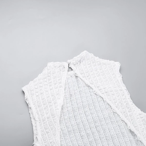 Detail of white crochet lace neckline with elegant pearl button on women's dress