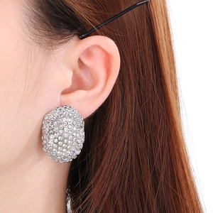 Detailed view of oval stainless steel earrings with pavé set cubic zirconia diamonds