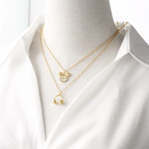 Gold double-layered necklace featuring Mickey mouse and headphone-shaped pendants