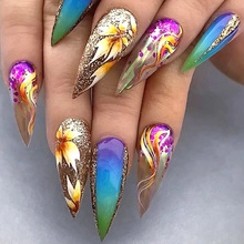 Close-up of long stiletto press-on nails with multi-color gradients and floral art