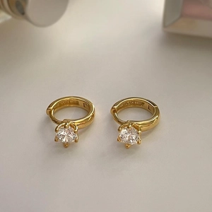 Minimalist 925 silver gold plated hoop earrings with zircon stones on cream background