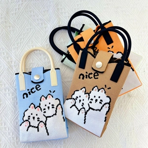 Detail of four colorful knitted mini bags with cute cat patterns and nice text design