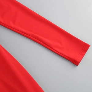 Detailed close-up of bright red long sleeve cuff with high-quality twin-needle stitching