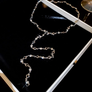 Silver heart necklace with sparkling crystals displayed on a black velvet jewelry box