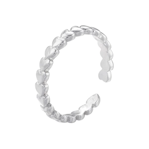 Macro view of adjustable silver heart-shaped ring band with polished metallic finish