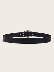 Close-up of the black leather belt back with silver oval hollow buckle and adjustment holes