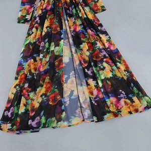 Detailed close-up of vibrant floral print on lightweight fabric with high-slit hemline