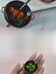 Detailed close-up of miniature frying pan toy with realistic food for dollhouse kitchen