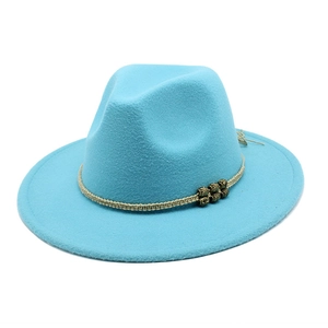 Detail of light blue wool fedora with beige woven band and bronze metal ornaments