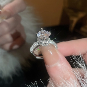 Macro shot of a silver zircon ring with brilliant cut center stone and pavé setting