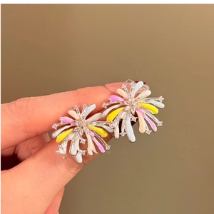 Detail of fireworks stud earrings featuring colorful enamel petals and sparkling crystals