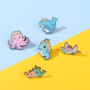 Five assorted ocean animal enamel pins including octopus and seahorse on a bicolor background