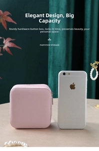 Compact pink jewelry organizer box with zipper shown next to phone for size scale