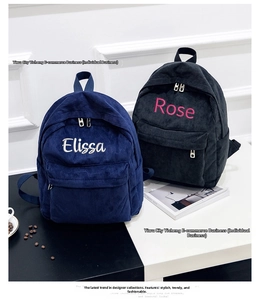 Detail of personalized embroidery on blue and black corduroy backpacks with front pockets