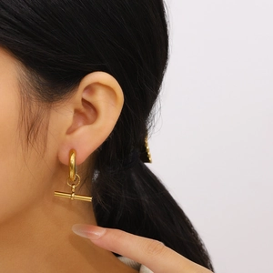 Fashionable 18K gold plated stainless steel T-bar hoop earrings worn by a model