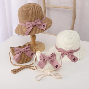 Detailed view of handmade straw hat set with pink bowknot and crossbody bag for girls