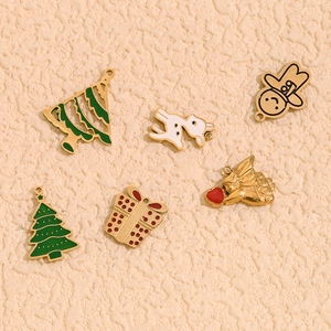 Flat lay of 14K gold plated Christmas charms including reindeer and trees for DIY jewelry