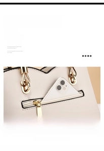 Detail of smooth zipper and back anti-theft pocket on beige faux leather handbag