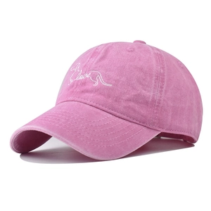 Detailed embroidery of a dachshund and love text on a vintage washed pink cotton baseball cap