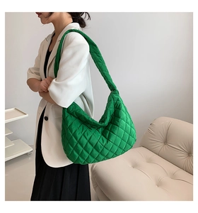 Dettaglio della borsa tote trapuntata verde con tracolla imbottita e texture in nylon