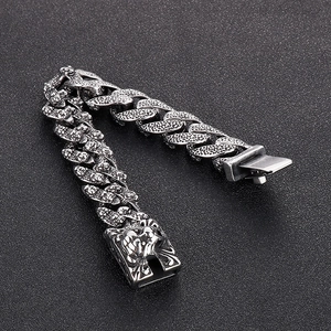 Detail of vintage silver tiger head steel chain bracelet with embossed clasp for men