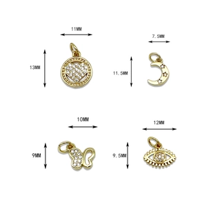 Four gold micro-pave pendants with sizes: heart, moon, butterfly, and evil eye charms