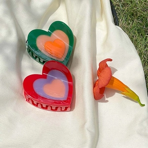 Colorful heart-shaped acetate hair claw clips in red and green for sweet summer hairstyling