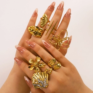 Golden ocean theme ring set featuring shell, flower and leaf designs on hand