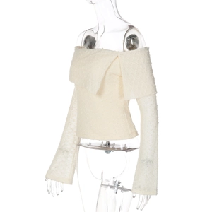 Detail of off-white off-shoulder top with textured mesh fabric and bell sleeve design