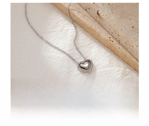 Detail view of heart pendant necklace made of titanium steel with sparkling zircon inlay