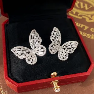 Sparkling silver butterfly stud earrings with zircon stones in a red jewelry gift box