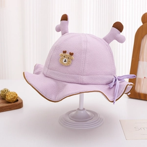 Detail of light purple baby bucket hat with cute 3D antlers and embroidered bear patch