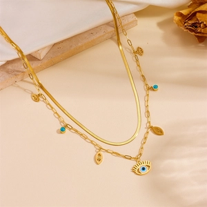 Close-up of double-layer gold snake chain necklace with turquoise eye pendant