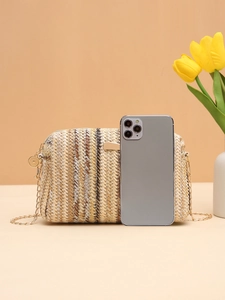 Macro shot of colorful woven straw camera bag showing its size next to a smartphone