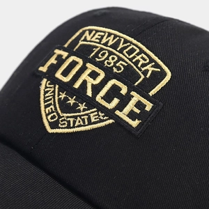 Close-up of high-density 3D embroidery on black mesh baseball cap with vintage New York logo